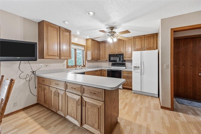 2914 Windy Ridge Rd NE, Swisher, IA 52338 - kitchen featuring white fridge with ice dispenser, black microwave, range with electric stovetop, light wood-type flooring, and a textured ceiling