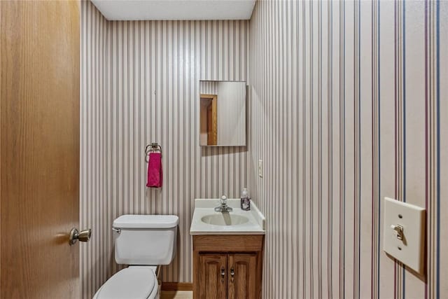 2914 Windy Ridge Rd NE, Swisher, IA 52338 - half bath with toilet, vanity, and wallpapered walls