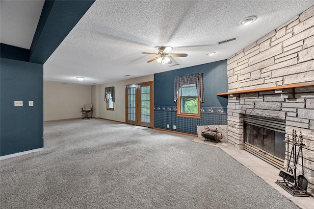 2914 Windy Ridge Rd NE, Swisher, IA 52338 - unfurnished living room with a fireplace, a ceiling fan, a textured ceiling, carpet flooring, and baseboards