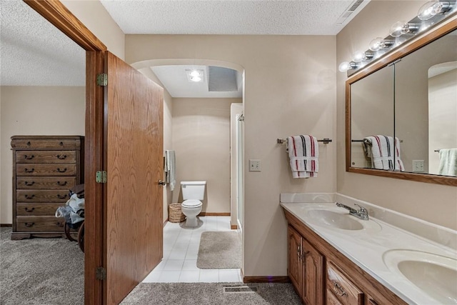2914 Windy Ridge Rd NE, Swisher, IA 52338 - full bath featuring double vanity, a textured ceiling, toilet, and baseboards