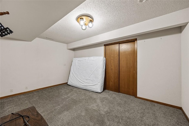 2914 Windy Ridge Rd NE, Swisher, IA 52338 - unfurnished bedroom featuring carpet flooring, a textured ceiling, baseboards, and a closet