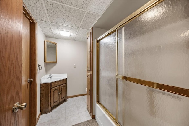 2914 Windy Ridge Rd NE, Swisher, IA 52338 - full bath featuring a paneled ceiling, vanity, tile patterned floors, enclosed tub / shower combo, and baseboards