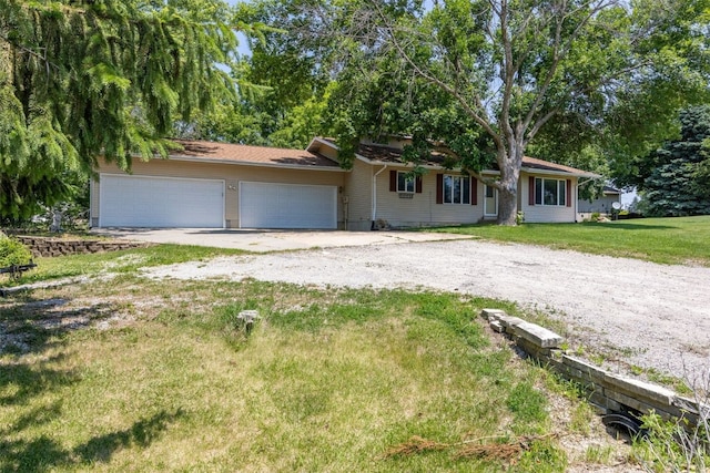 2914 Windy Ridge Rd NE, Swisher, IA 52338 - ranch-style house with dirt driveway, an attached garage, and a front yard