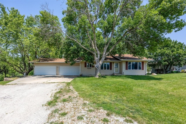 2914 Windy Ridge Rd NE, Swisher, IA 52338 - ranch-style house with concrete driveway, an attached garage, and a front yard