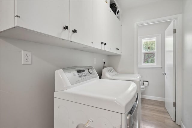 75 Jefferson Ave SW, Swisher, IA 52238 - laundry room featuring washing machine and dryer, light wood-type flooring, and baseboards