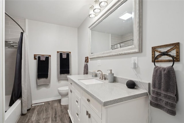 75 Jefferson Ave SW, Swisher, IA 52238 - full bath featuring vanity, toilet, wood finished floors, baseboards, and shower / bathtub combination with curtain