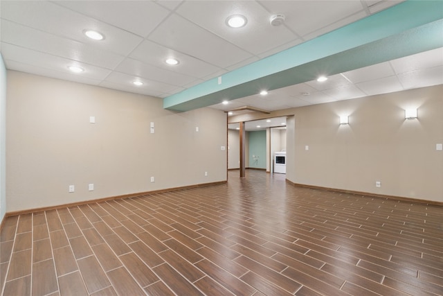 1206 W State St, Williamsburg, IA 52361 - spare room with wood finished floors, a smoke detector, baseboards, a paneled ceiling, and recessed lighting