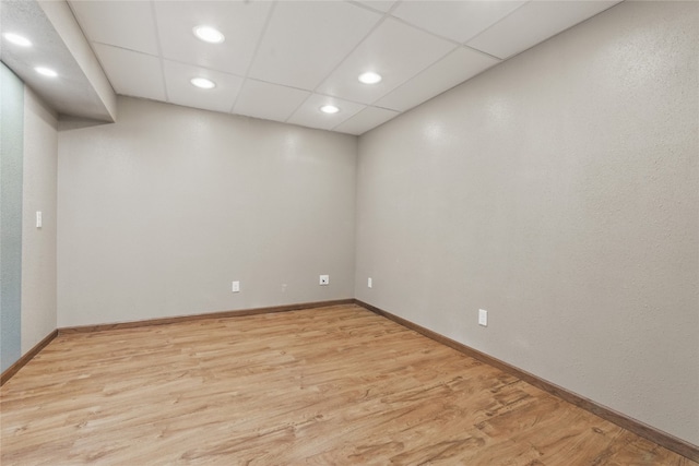 1206 W State St, Williamsburg, IA 52361 - empty room featuring light wood-style flooring, recessed lighting, baseboards, and a paneled ceiling
