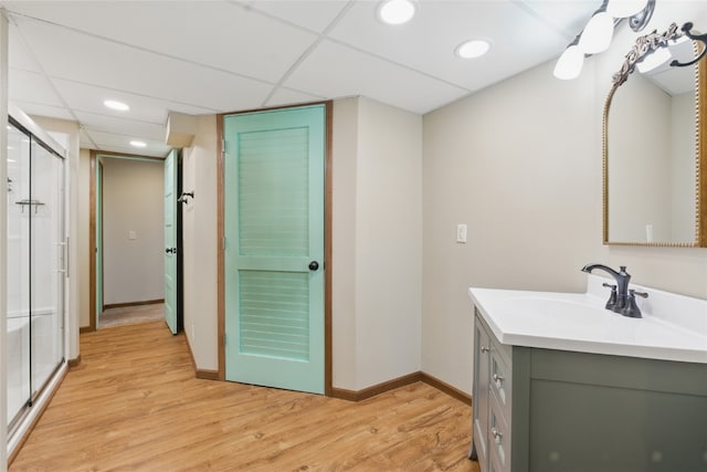 1206 W State St, Williamsburg, IA 52361 - full bathroom featuring vanity, wood finished floors, a shower stall, baseboards, and recessed lighting