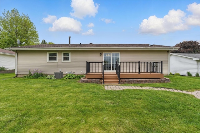 1206 W State St, Williamsburg, IA 52361 - rear view of house featuring a wooden deck, a lawn, and central AC unit