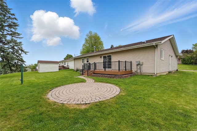 1206 W State St, Williamsburg, IA 52361 - rear view of house featuring a wooden deck and a lawn