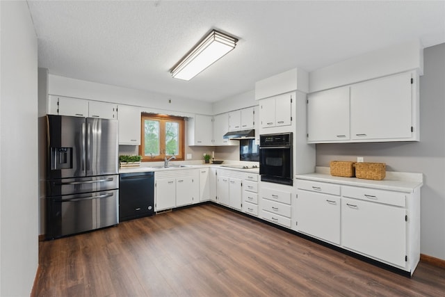 1206 W State St, Williamsburg, IA 52361 - kitchen featuring black appliances, a sink, dark wood-style floors, and light countertops