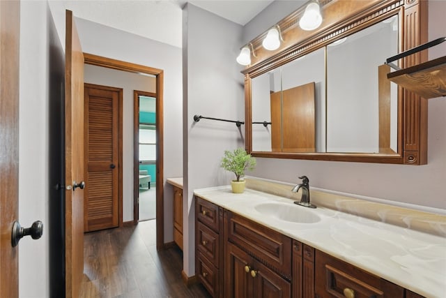 1206 W State St, Williamsburg, IA 52361 - bathroom featuring wood finished floors and vanity