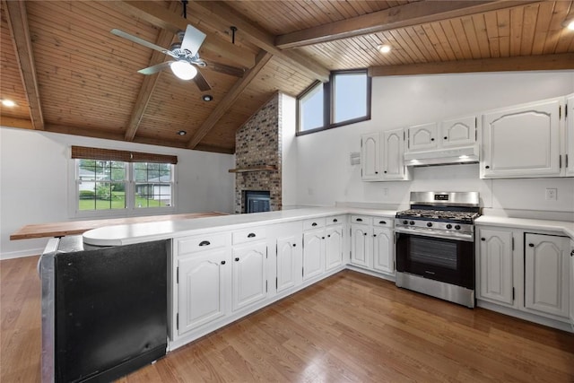 1220 Northwood Ln, Muscatine, IA 52761 - kitchen featuring stainless steel gas range oven, under cabinet range hood, a peninsula, wooden ceiling with exposed beams, and a ceiling fan
