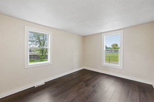 1298 14th Ave, Marion, IA 52302 - empty room with dark wood-type flooring, baseboards, and a textured ceiling