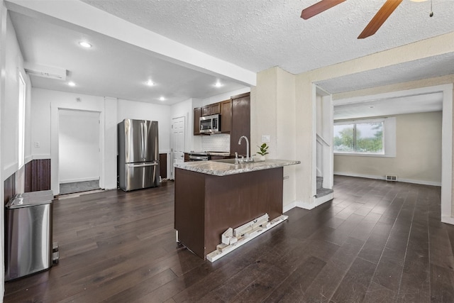 1298 14th Ave, Marion, IA 52302 - kitchen featuring stainless steel appliances, a ceiling fan, a peninsula, dark wood-style flooring, and recessed lighting