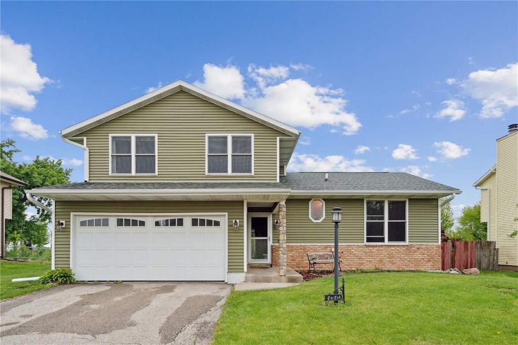 4040 Willowood Ave, Marion, IA 52302 - view of front of house featuring a garage, driveway, and brick siding