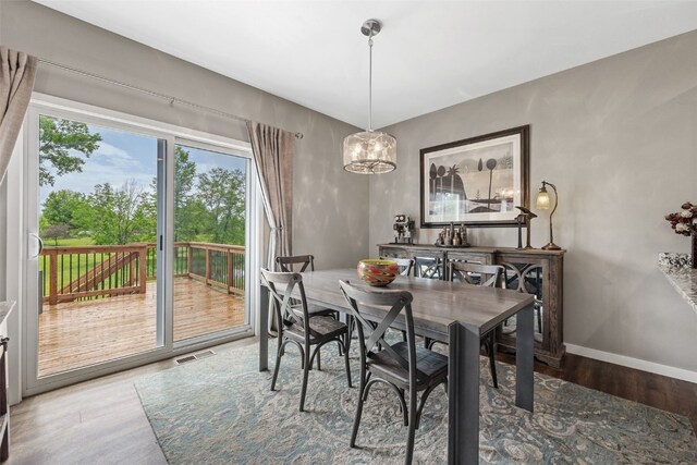 1225 Daisy Cir, North Liberty, IA 52317 - dining space with wood finished floors, baseboards, and a chandelier