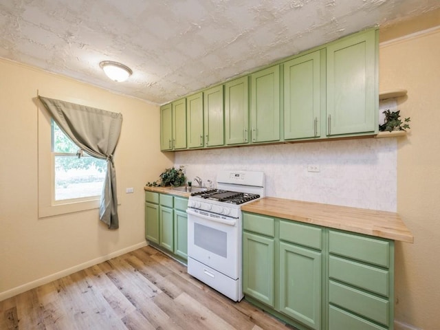 259 25th Ave SW, Cedar Rapids, IA 52404 - kitchen with gas range gas stove, green cabinets, a sink, open shelves, and wood counters