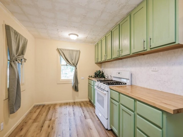 259 25th Ave SW, Cedar Rapids, IA 52404 - kitchen featuring gas range gas stove, green cabinetry, butcher block counters, and backsplash