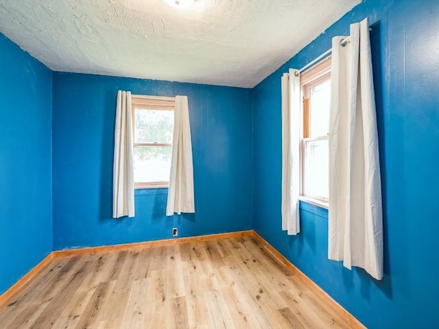 259 25th Ave SW, Cedar Rapids, IA 52404 - unfurnished room with wood finished floors, baseboards, and a textured ceiling