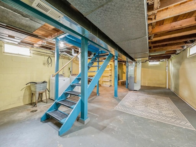 259 25th Ave SW, Cedar Rapids, IA 52404 - below grade area with washer and clothes dryer, stairway, and heating unit