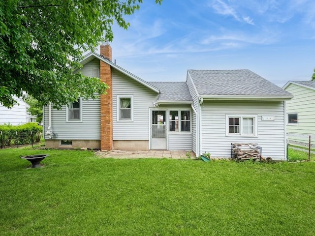 259 25th Ave SW, Cedar Rapids, IA 52404 - rear view of house featuring a chimney, a shingled roof, and a yard