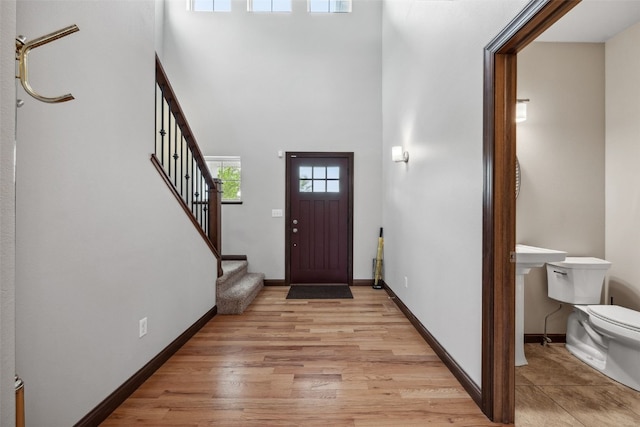 2913 Caspian Rd, Hiawatha, IA 52233 - entrance foyer featuring a high ceiling, stairway, light wood finished floors, and baseboards