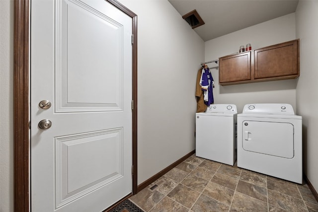 2913 Caspian Rd, Hiawatha, IA 52233 - laundry area featuring cabinet space, washing machine and dryer, stone finish floors, and baseboards