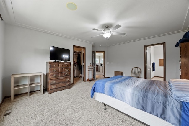 2913 Caspian Rd, Hiawatha, IA 52233 - bedroom featuring a walk in closet, a closet, carpet flooring, crown molding, and a ceiling fan
