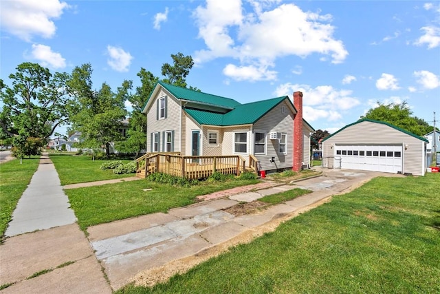 405 6th Ave, Clarence, IA 52216 - view of front of home featuring an outdoor structure, a garage, a deck, a chimney, and a front lawn