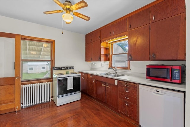 405 6th Ave, Clarence, IA 52216 - kitchen with radiator heating unit, white appliances, a sink, light countertops, and ceiling fan