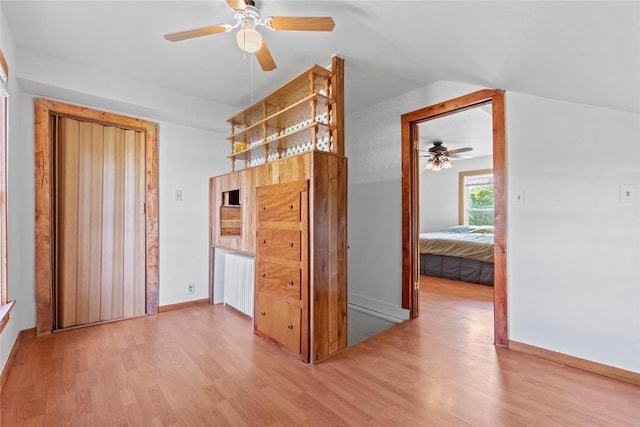 405 6th Ave, Clarence, IA 52216 - unfurnished bedroom with wood finished floors, radiator, baseboards, and vaulted ceiling