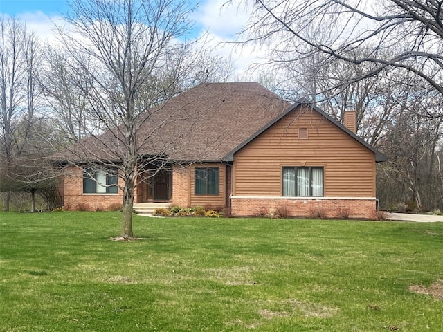 1354 Fox Meadow Ct NE, Swisher, IA 52338 - view of front of home with brick siding, a chimney, and a front yard