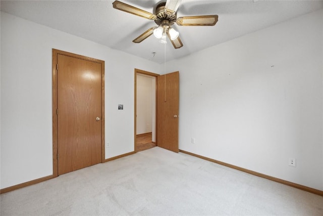 80 Florence Way, North Liberty, IA 52317 - unfurnished bedroom featuring light colored carpet, baseboards, and ceiling fan