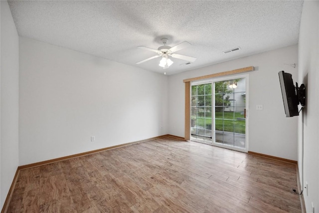 80 Florence Way, North Liberty, IA 52317 - empty room featuring wood finished floors, ceiling fan, a textured ceiling, and baseboards