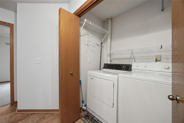 80 Florence Way, North Liberty, IA 52317 - laundry area featuring separate washer and dryer, light wood-style floors, and baseboards
