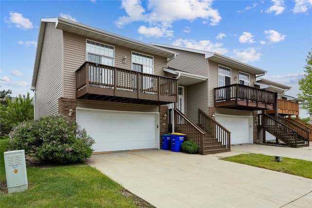 80 Florence Way, North Liberty, IA 52317 - view of front of home with stairs, a garage, concrete driveway, and a balcony