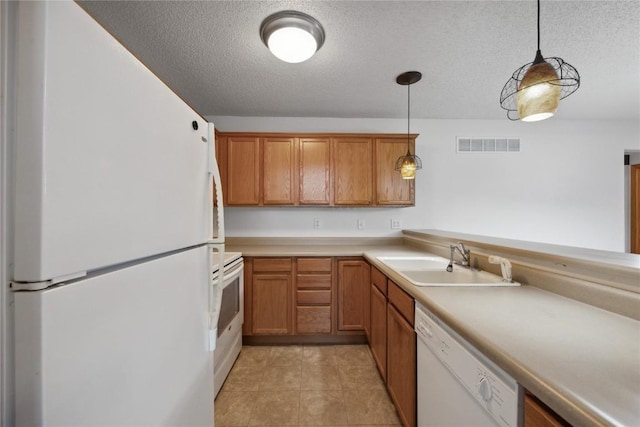 80 Florence Way, North Liberty, IA 52317 - kitchen featuring white appliances, a sink, a textured ceiling, decorative light fixtures, and light countertops