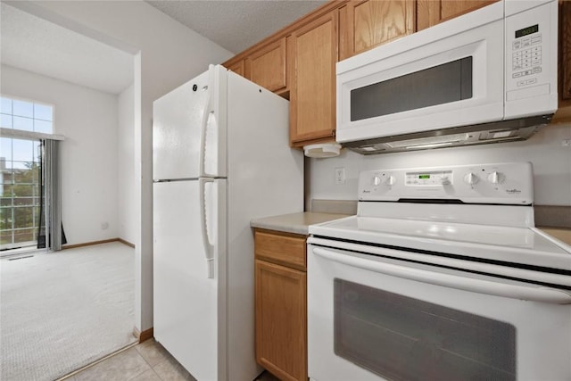 80 Florence Way, North Liberty, IA 52317 - kitchen with white appliances, light countertops, light carpet, light tile patterned floors, and baseboards