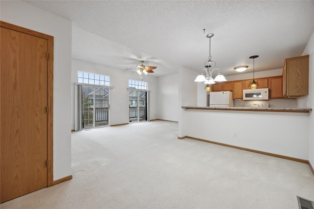 80 Florence Way, North Liberty, IA 52317 - unfurnished living room with light carpet, baseboards, a ceiling fan, and a textured ceiling