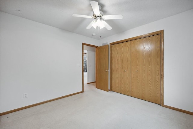 80 Florence Way, North Liberty, IA 52317 - unfurnished bedroom with light carpet, baseboards, a closet, and a ceiling fan