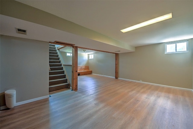 1139 H Ave NE, Cedar Rapids, IA 52402 - below grade area with light wood-type flooring, baseboards, and stairway