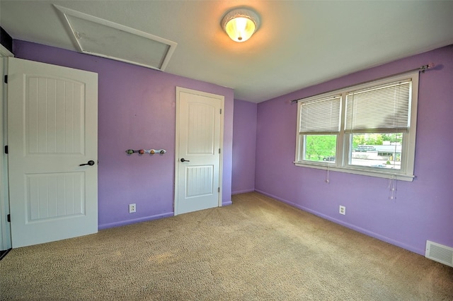 1139 H Ave NE, Cedar Rapids, IA 52402 - unfurnished bedroom featuring carpet, attic access, and baseboards