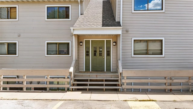 215 40th St Dr SE Unit 304, Cedar Rapids, IA 52403 - view of exterior entry featuring a shingled roof