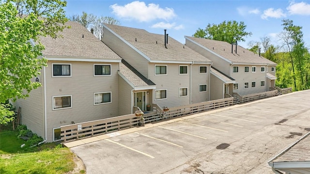 215 40th St Dr SE Unit 304, Cedar Rapids, IA 52403 - rear view of property featuring uncovered parking