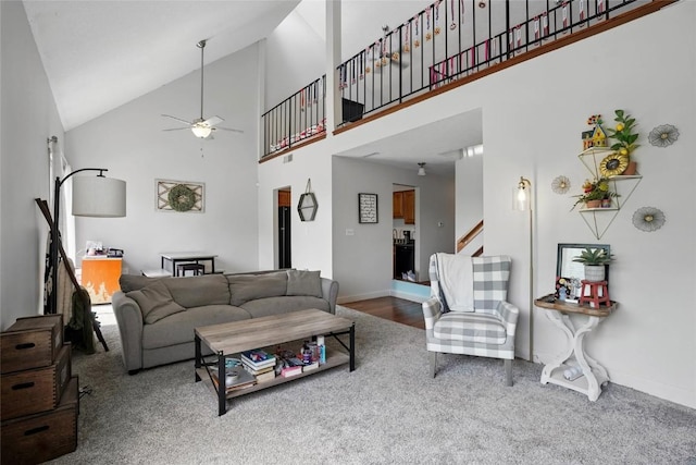 215 40th St Dr SE Unit 304, Cedar Rapids, IA 52403 - living room with ceiling fan, carpet, high vaulted ceiling, baseboards, and stairs