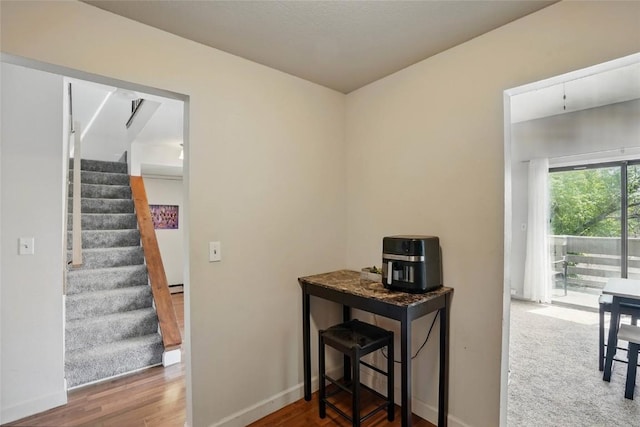 215 40th St Dr SE Unit 304, Cedar Rapids, IA 52403 - hall featuring stairway, wood finished floors, and baseboards