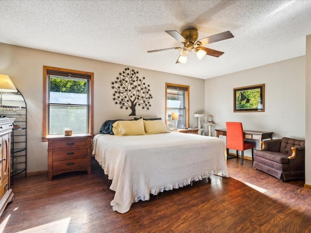 1901 42nd St SE, Cedar Rapids, IA 52403 - bedroom featuring dark wood-type flooring, a textured ceiling, baseboards, and a ceiling fan