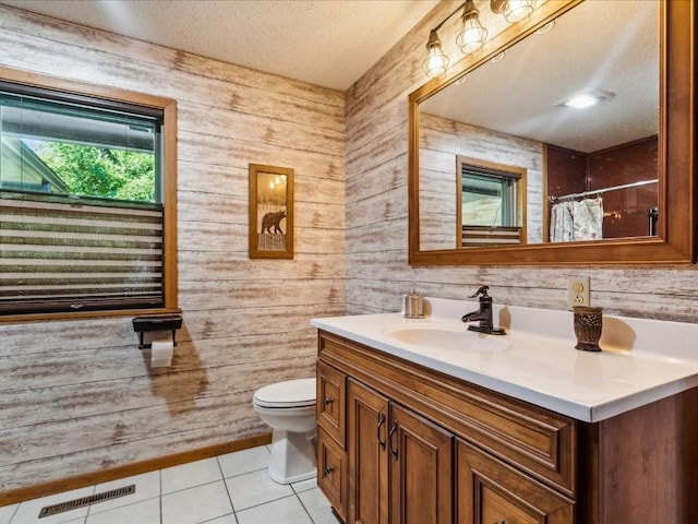 1901 42nd St SE, Cedar Rapids, IA 52403 - bathroom with toilet, vanity, wooden walls, tile patterned flooring, and a shower with curtain